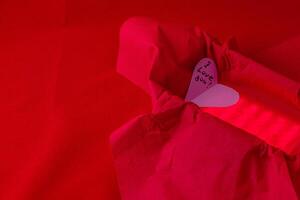 hand cut heart made from paper inside of a red box with a back light for effect photo
