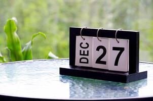 27 December calendar on marble table with customizable space for text. December calendar concept photo