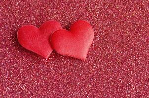 Top view of heart shapes on red color cover with customizable space for text photo