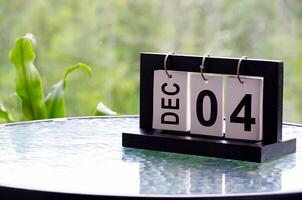 4 December calendar on marble table with customizable space for text. December calendar concept photo