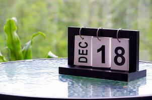 18 December calendar on marble table with customizable space for text. December calendar concept photo