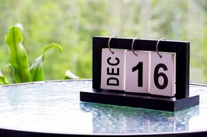 16 December calendar on marble table with customizable space for text. December calendar concept photo