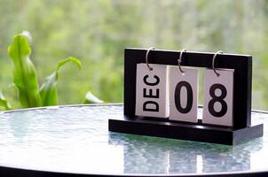 8 December calendar on marble table with customizable space for text. December calendar concept photo