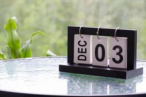 3 December calendar on marble table with customizable space for text. December calendar concept photo