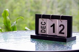 12 December calendar on marble table with customizable space for text. December calendar concept photo