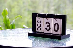 30 December calendar on marble table with customizable space for text. December calendar concept photo