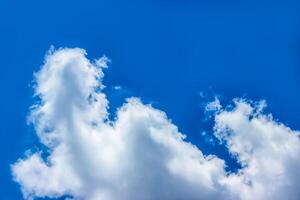 background texture of a blue summer sky with a large white cloud photo