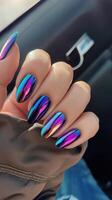 Close-up of multicolored chrome nails with holographic effect. Glossy manicure and modern nail art photo