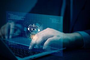 A person using a laptop with an image of a robot on the screen photo