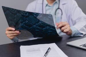 A man in a lab coat is holding a piece of paper photo