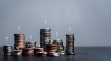 Coins and candles on a table with a gray background photo
