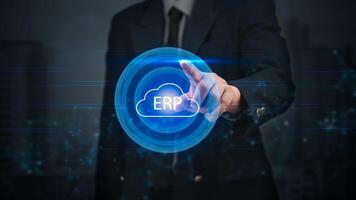 Man in suit touching cloud computing erp button photo