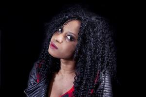 portrait of beautiful young african american girl wearing leather jacket photo