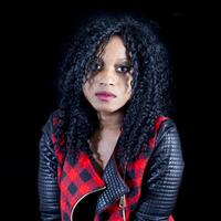 portrait of beautiful young african american girl wearing leather jacket photo