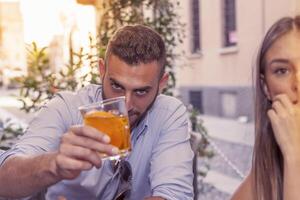 young couple takes a drink in a downtown bar photo