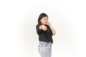 beautiful Asian woman poses with her fingers under her eyes, capturing a poignant crying expression against a white background photo