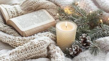 An open bible and Christmas candle and fir branches decoration photo