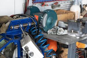 Mess on a working table with metallic tools photo