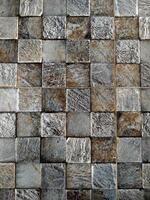 A close up of a stone wall with a square pattern photo