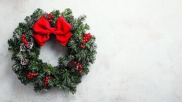 A wreath with red bows and holly berries photo