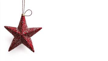 A red star ornament hanging from a string photo