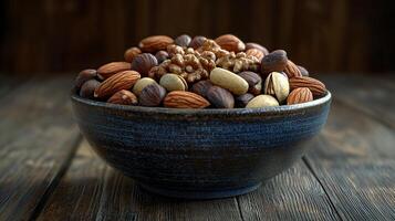 A bowl of mixed nuts on a wooden table photo