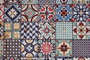vintage of decorative ceramic tiles displays an array of intricate patterns and vibrant colors, including blues, reds, and greens photo