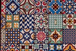 retro of decorative ceramic tiles displays an array of intricate patterns and vibrant colors, including blues, reds, and greens photo