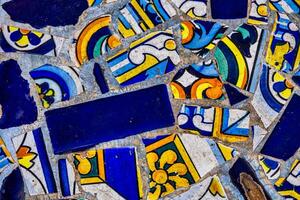 A blue collection of decorative ceramic tiles displays an array of intricate patterns and vibrant colors, including blues, reds, and greens photo