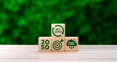 Wooden Blocks Displaying Net Zero, CO2 Emission Reduction, and 2050 Target Goals Against Green Background, Representing Climate Action and Sustainability Milestones photo