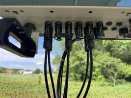 Input of cables to the solar inverter. Solar inverter hybrid isometric system controller with switch. photo
