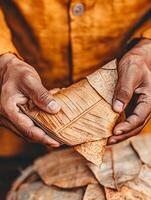 Hands holding intricately folded leaves, showcasing cultural artistry and tradition. photo