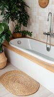 Modern bathroom with a stylish bathtub and lush greenery for relaxation. photo