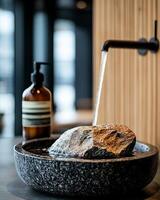 A serene water feature with a stone centerpiece and minimalist design, promoting tranquility. photo