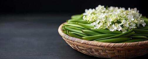 Fresh green vegetables and delicate white flowers arranged in a woven basket. photo