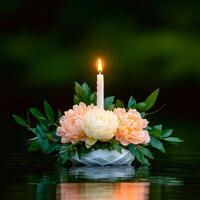 Tranquil candle floating on water surrounded by beautiful blossoms in serene nature. photo