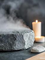 Relaxing stone and candle setup with steam, perfect for wellness and tranquility. photo