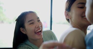 Selective focus, Two happy women having fun playing with a little boy in a coffee shop. Family enjoying time together. Happy lifestyle. photo