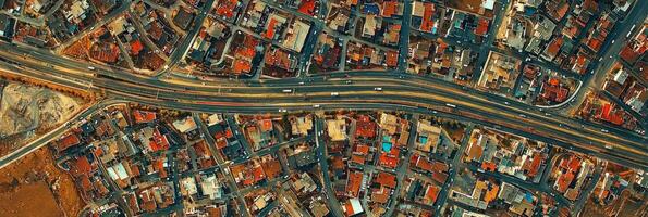 Urban Sprawl with Roads and Highways. A top-down drone view of a sprawling city, residential blocks photo