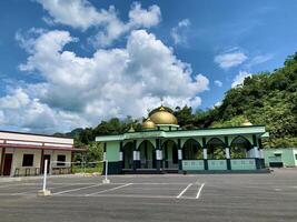 a gold domed mosque with a blue sky as a background photo