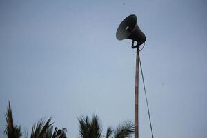 Tall Loudspeaker Pole Against Clear Sky, Symbolizing Communication and Public Announcements photo