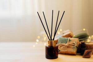 Home winter aroma fragrance diffuser on wooden table. Interior elements. Christmas and Winter decoration. Copy space photo