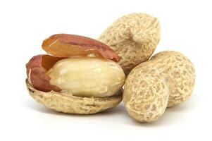 Close-Up of Peanuts in Shell With Brown Skin on Surface Isolated on White Background photo