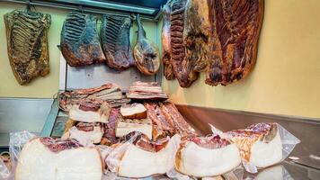 Assortment of cured meats displayed in a delicatessen, highlighting preservation methods for traditional European charcuterie, ideal for festive gatherings photo
