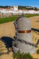 Stub posts linked in a chain on a quay photo