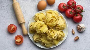 Chef is arranging ingredients around a plate of pasta video