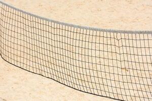 volleyball net on empty sand beach photo