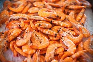Top view of raw whole tiger prawns on ice photo