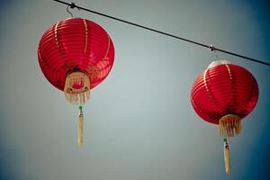 Red Chinese Paper Lanterns against a Blue Sky photo