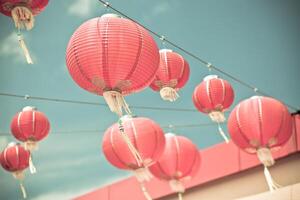 Red Chinese Paper Lanterns against a Blue Sky photo